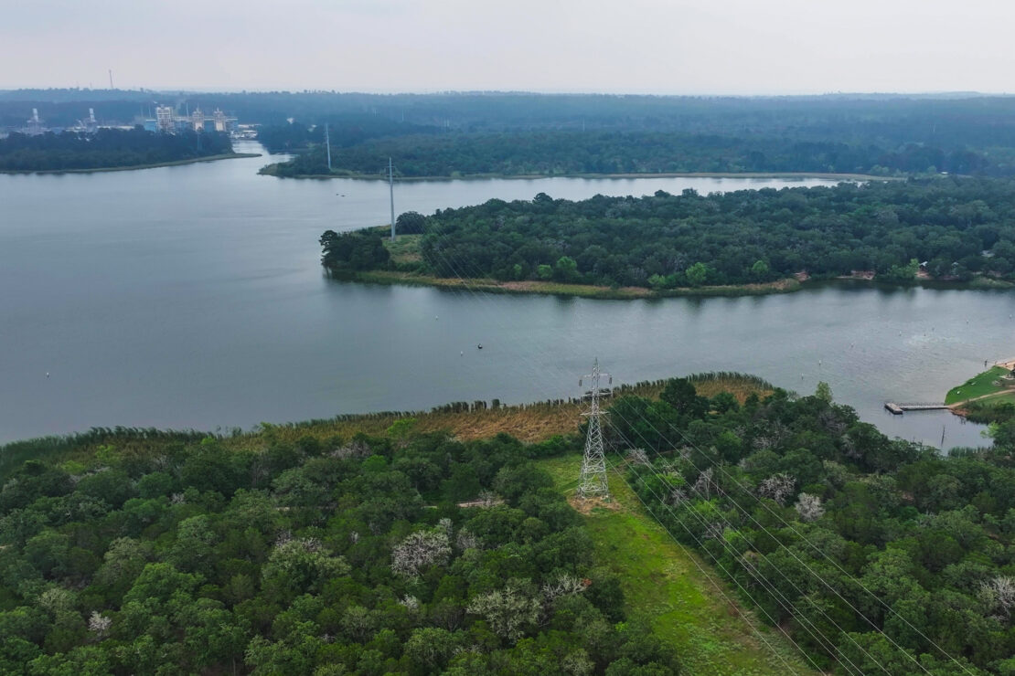An aerial view of Lake Bastrop during the winter with the power plant in the background.