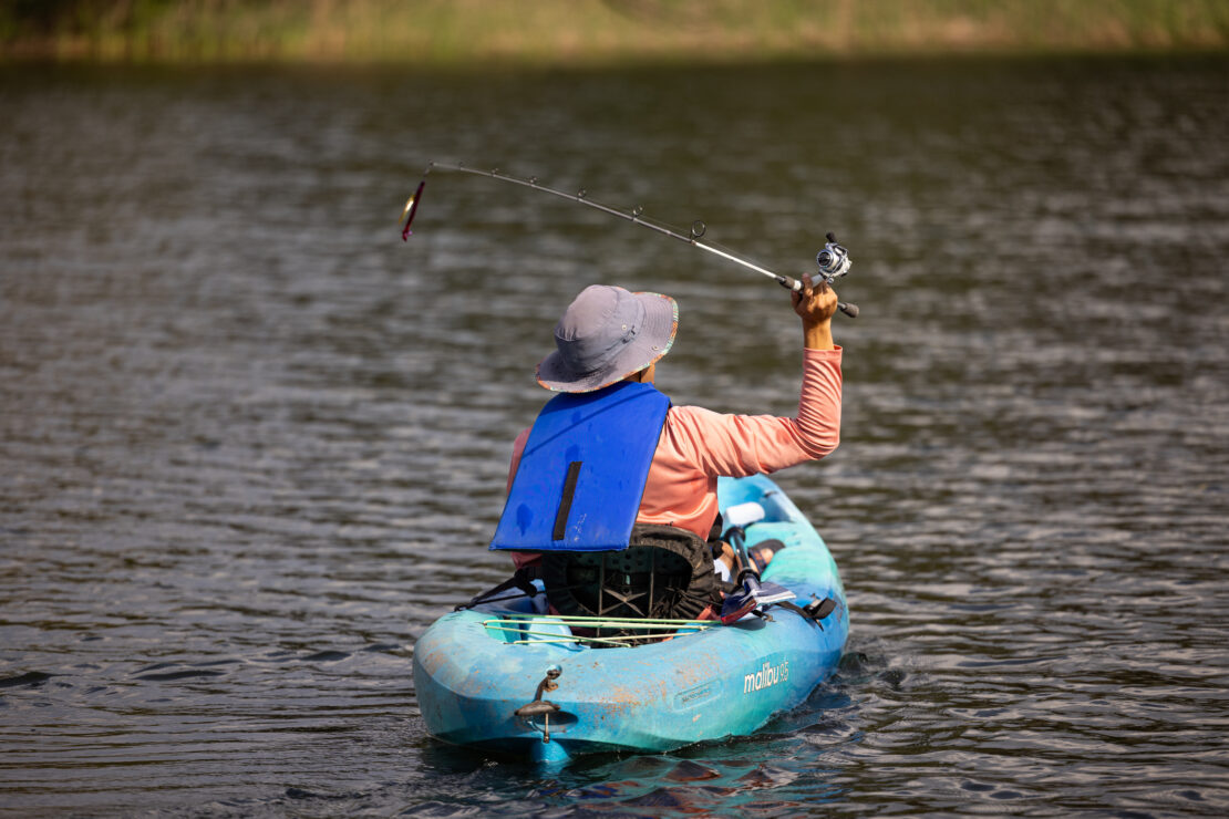 Man in a kayak fishing on Lake Bastrop.