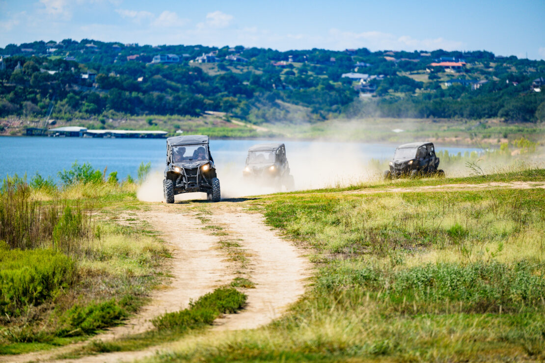 Three UTVs driving along Muleshoe Bend Recreation Area's lakeside trails.