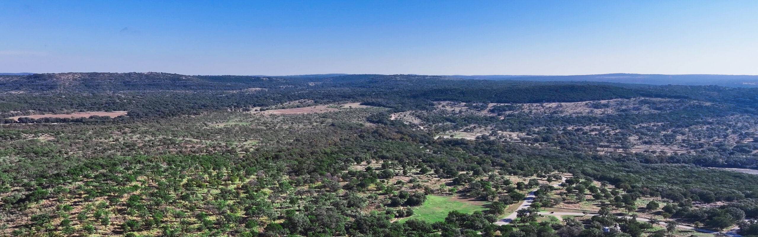 Aerial view of Canyon of the Eagles, showing rolling hills and expansive hill country landscape.