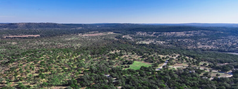 Aerial view of Canyon of the Eagles, showing rolling hills and expansive hill country landscape.